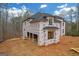 New construction home with weather protection showing a new black roof and dark windows at 2015 Fontainbleau Dr, Conyers, GA 30094