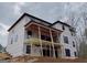 New construction exterior featuring a covered porch, windows and wrapped in ProLinx weather resistant house wrap at 2015 Fontainbleau Dr, Conyers, GA 30094
