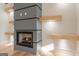 Close up of the fireplace featuring a black hearth and modern wood accent shelves and hardwood floors at 2015 Fontainbleau Dr, Conyers, GA 30094