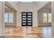 Grand foyer featuring hardwood floors, high ceilings, and a stylish front door at 2015 Fontainbleau Dr, Conyers, GA 30094