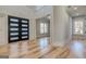 Welcoming foyer with hardwood floors, modern front door and view into a sunlit room at 2015 Fontainbleau Dr, Conyers, GA 30094