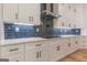 This kitchen has white cabinets, dark hardware, subway tile backsplash, and an electric cooktop at 2015 Fontainbleau Dr, Conyers, GA 30094