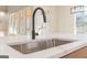 The kitchen sink is stainless steel and is mounted into white quartz countertops at 2015 Fontainbleau Dr, Conyers, GA 30094