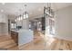 Open concept kitchen with large island, fireplace, stainless steel appliances, and hardwood floors at 2015 Fontainbleau Dr, Conyers, GA 30094