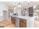 Open concept kitchen with large island, stainless steel appliances, fireplace, and hardwood floors at 2015 Fontainbleau Dr, Conyers, GA 30094