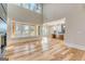 Spacious living room with high ceilings, large windows, hardwood floors and open floor plan to the kitchen at 2015 Fontainbleau Dr, Conyers, GA 30094