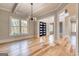 Bright living room showcasing hardwood floors, a modern chandelier, and lots of natural light at 2015 Fontainbleau Dr, Conyers, GA 30094