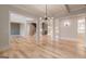 Spacious living room with hardwood floors, modern lighting, and open layout to staircase and fireplace at 2015 Fontainbleau Dr, Conyers, GA 30094