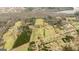 Scenic aerial view highlighting the property's land, trees, proximity to neighborhood, and water views at 757 Fischer Rd, Sharpsburg, GA 30277