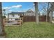 The home's backyard boasts a wooden fence, a fire pit, and a view of the multi-level deck at 757 Fischer Rd, Sharpsburg, GA 30277