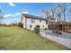 A spacious backyard featuring an expansive lawn, a wooden fence and a view of the home's rear exterior at 757 Fischer Rd, Sharpsburg, GA 30277