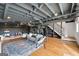 Open basement with a gray painted ceiling and hardwood floors at 757 Fischer Rd, Sharpsburg, GA 30277