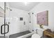 Bathroom featuring tiled glass enclosed shower with black hardware and a mosaic tile floor at 757 Fischer Rd, Sharpsburg, GA 30277