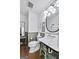 Charming bathroom featuring vintage-style sink, wood floors and beadboard trim at 757 Fischer Rd, Sharpsburg, GA 30277