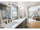 Stylish bathroom featuring double sinks with quartz countertop and views to the bedroom at 757 Fischer Rd, Sharpsburg, GA 30277