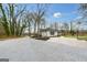 Exterior angle of a home showcasing a circular driveway and verdant yard at 757 Fischer Rd, Sharpsburg, GA 30277