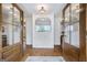 Bright foyer with a decorative stone accent wall and glass-paneled double doors at 757 Fischer Rd, Sharpsburg, GA 30277
