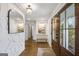 Welcoming foyer featuring hardwood floors, a stylish mirror, and a cozy bench at 757 Fischer Rd, Sharpsburg, GA 30277