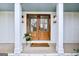 Inviting front entrance with double doors, potted plants, and a welcome mat at 757 Fischer Rd, Sharpsburg, GA 30277
