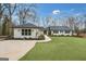 Charming single-story home featuring a well-manicured lawn, black roof, and a welcoming walkway at 757 Fischer Rd, Sharpsburg, GA 30277