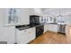 Well-appointed kitchen with black marble counters, modern appliances, and ample cabinet space at 757 Fischer Rd, Sharpsburg, GA 30277