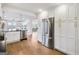 Open kitchen with stainless appliances, custom cabinets, and hardwood flooring at 757 Fischer Rd, Sharpsburg, GA 30277