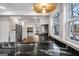Spacious kitchen boasts custom cabinets, stainless steel appliances, and elegant lighting at 757 Fischer Rd, Sharpsburg, GA 30277