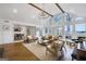 Open-concept living room with a vaulted ceiling, hardwood floors, and ample natural light at 757 Fischer Rd, Sharpsburg, GA 30277