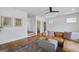 Relaxing living room space with wood floors, tan leather couch and neutral colors at 757 Fischer Rd, Sharpsburg, GA 30277