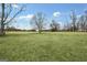 Open field with a scattering of trees, providing a serene setting and plenty of space at 757 Fischer Rd, Sharpsburg, GA 30277