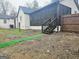 Backyard view features screen porch, steps and wooden fence at 3930 W Side Pl, Ellenwood, GA 30294