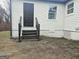 Exterior view of backyard with entry door and vinyl siding at 3930 W Side Pl, Ellenwood, GA 30294