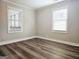 Bedroom featuring two large windows providing plenty of natural light at 3930 W Side Pl, Ellenwood, GA 30294