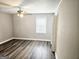 Bright bedroom with ceiling fan and new flooring at 3930 W Side Pl, Ellenwood, GA 30294