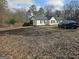 Exterior view of a home with a car parked nearby and a fenced yard at 3930 W Side Pl, Ellenwood, GA 30294