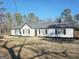 Ranch style home featuring a new roof, white siding, and black shutters against a bright blue sky at 3930 W Side Pl, Ellenwood, GA 30294