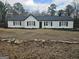Charming single-story home featuring white siding, black shutters, and well-maintained landscaping at 3930 W Side Pl, Ellenwood, GA 30294