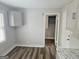 Bright kitchen features modern cabinets, gray walls, wood floors, and natural light from a window at 3930 W Side Pl, Ellenwood, GA 30294