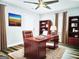 Office featuring a handsome wood desk, wood bookcases, and an area rug at 3930 W Side Pl, Ellenwood, GA 30294