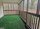Enclosed outdoor space with green turf and wood railing at 3930 W Side Pl, Ellenwood, GA 30294