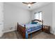 Bedroom featuring neutral walls, ceiling fan, carpeted floors, and a bed with a wooden frame at 117 Coulter Woods Dr, Locust Grove, GA 30248