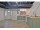 A partially finished basement boasts an open layout, including a kitchenette with sink and a door to the outside at 101 Nightwind Ct, Peachtree City, GA 30269