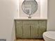 This bathroom features a green vanity and a round mirror at 101 Nightwind Ct, Peachtree City, GA 30269