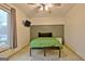 Modern bedroom with a ceiling fan, mounted TV, and a bed with a minimalist metal frame at 101 Nightwind Ct, Peachtree City, GA 30269