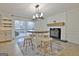 Light and airy dining area features stylish lighting and a wood burning fireplace at 101 Nightwind Ct, Peachtree City, GA 30269