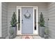 Welcoming front door adorned with potted plants and a seasonal wreath at 101 Nightwind Ct, Peachtree City, GA 30269