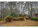 Backyard area, featuring a playset on a spacious lot with mature trees at 308 Tulipwood Sw Cir, Conyers, GA 30094