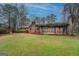 Expansive backyard showcasing a covered patio, lush lawn, and a play area for children, perfect for Gathering gatherings at 308 Tulipwood Sw Cir, Conyers, GA 30094