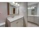 Bathroom featuring a vanity with drawers, a bright mirror and decorative light fixture at 308 Tulipwood Sw Cir, Conyers, GA 30094