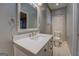 Modern bathroom features a marble countertop vanity and neutral color palette at 308 Tulipwood Sw Cir, Conyers, GA 30094